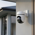 TP-Link Tapo TC42 outdoor pan tilt security WiFi camera mounted on exterior house wall
