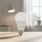 TP-Link Tapo L520E smart WiFi light bulb glowing daylight white in modern living room