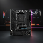 ASUS ROG Crosshair VIII Impact motherboard standing upright on a desk in a real gaming workspace.