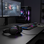 ASUS ROG Fusion II 300 gaming headset placed on a gaming desk with RGB-lit gaming setup in the background.