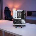 ASUS ROG Strix B660-A motherboard displayed on a real gaming desk setup in a home environment.