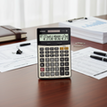 Casio DJ-240D PLUS check calculator on a professional accounting desk.