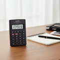 Casio HL-4A pocket calculator on a modern workspace.