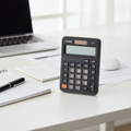 Casio MX-8B mini desk calculator on a modern office desk.