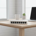 TP-Link LS1008 compact Ethernet switch on a minimal home desk setup.