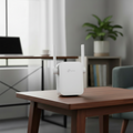 TP-Link RE205 WiFi extender placed on a table in a real home environment setup.