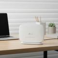 TP-Link TL-MR105 4G LTE router on desk with blurred modern workspace background.