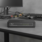TP-Link 16-port network switch standing upright on desk with clear port visibility and blurred office background