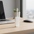 TP-Link UE300C USB-C Ethernet adapter on desk with blurred modern workspace background.