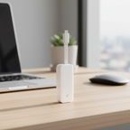 TP-Link UE300C USB-C Ethernet adapter on desk with blurred modern workspace background.