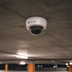 TP-Link VIGI C230 dome camera mounted in a parking area for night surveillance.