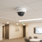 TP-Link VIGI C240 dome camera mounted at an indoor ceiling corner in a modern office lobby.