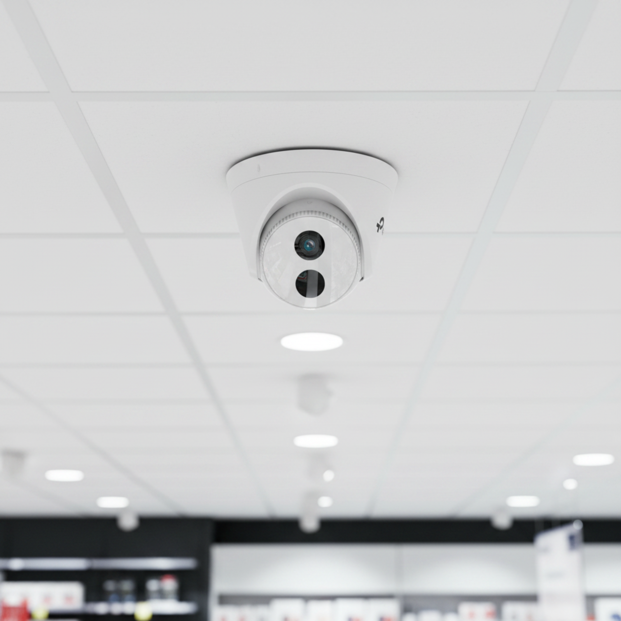 TP-Link VIGI C430I turret camera mounted in a retail store ceiling for aisle surveillance.