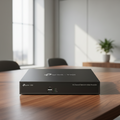 TP-Link VIGI NVR1016H 16-channel network video recorder displayed on a premium office desk with natural daylight.